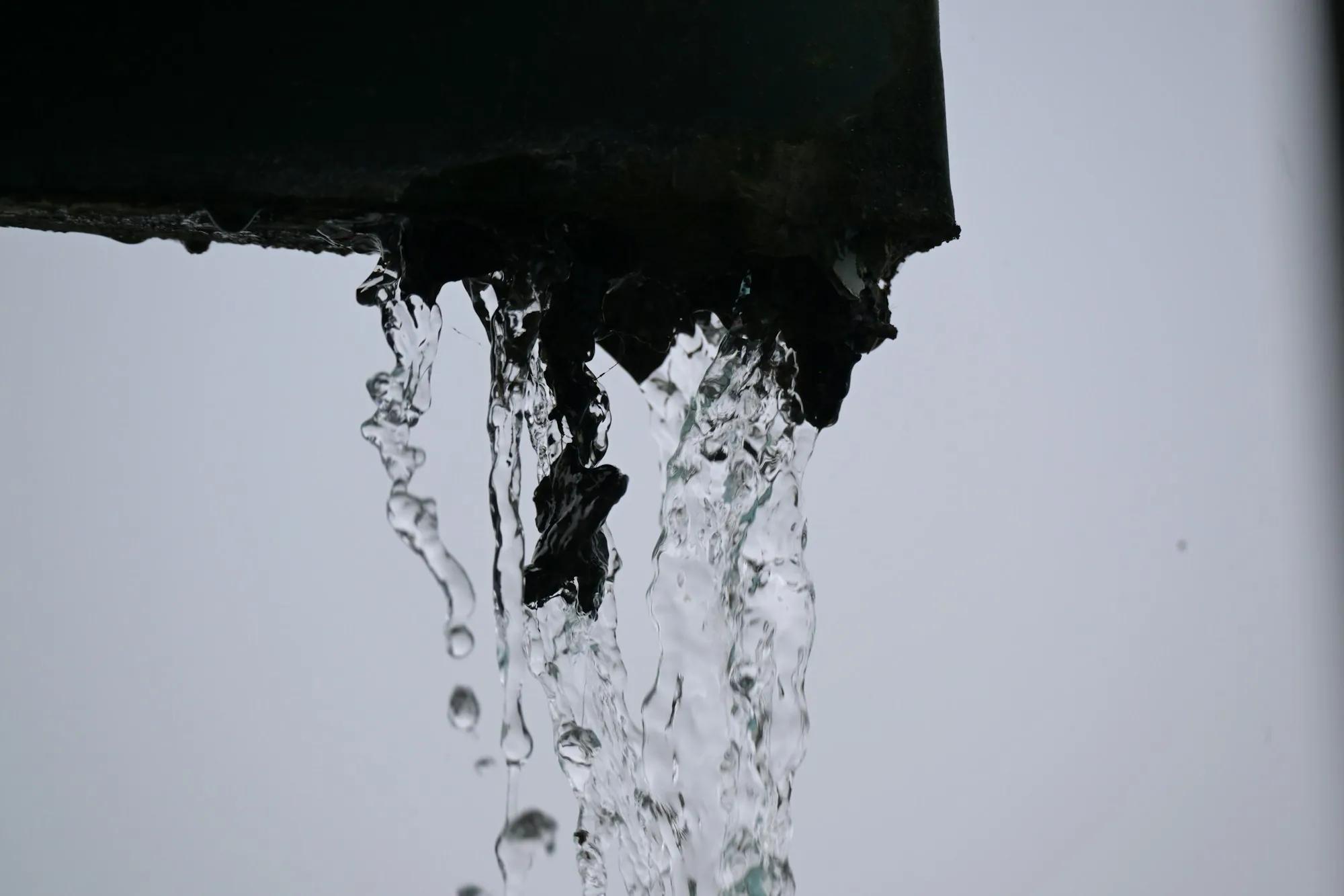 Water cascading over the edge of a gutter
