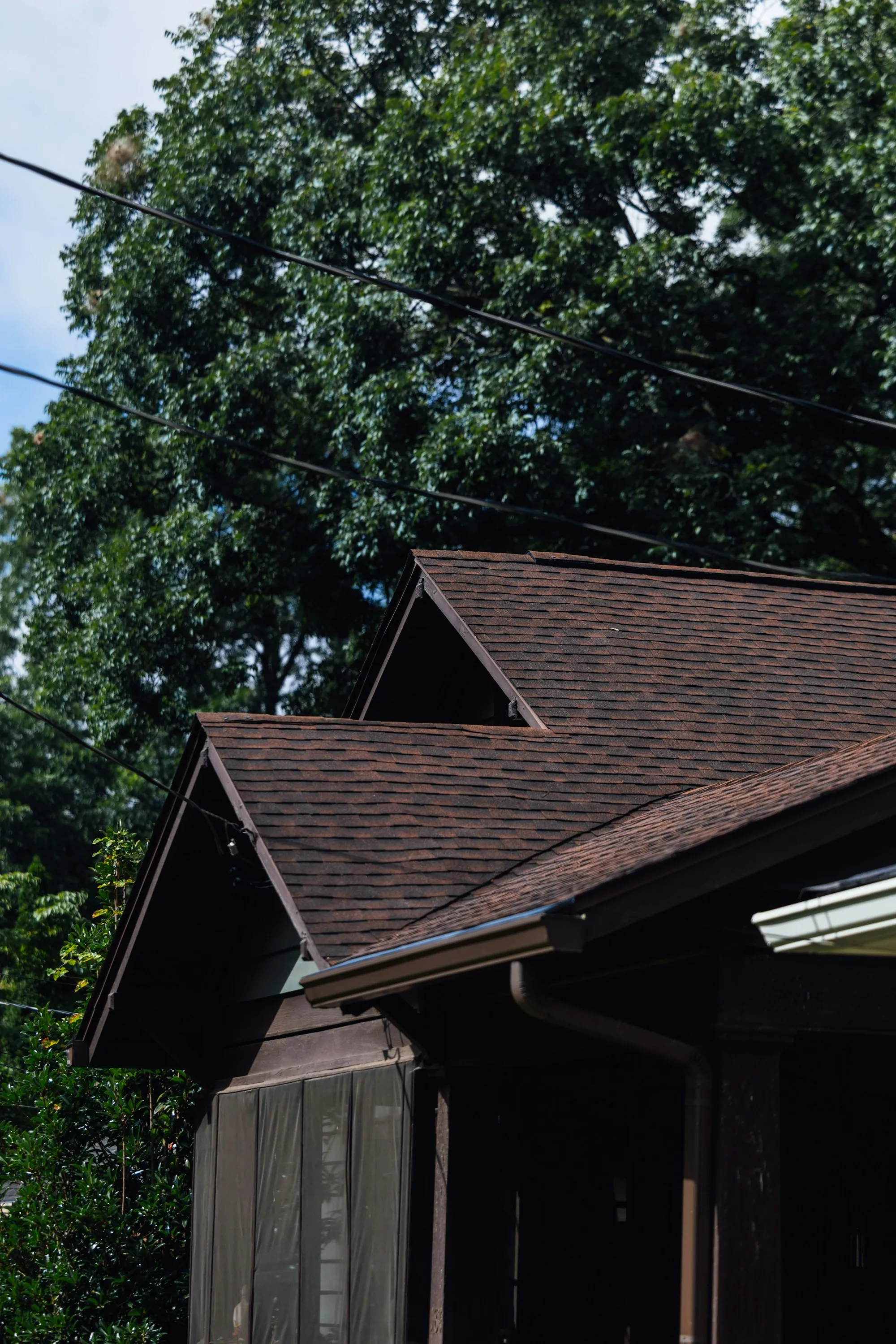 Brown shingled roof where two slopes meet